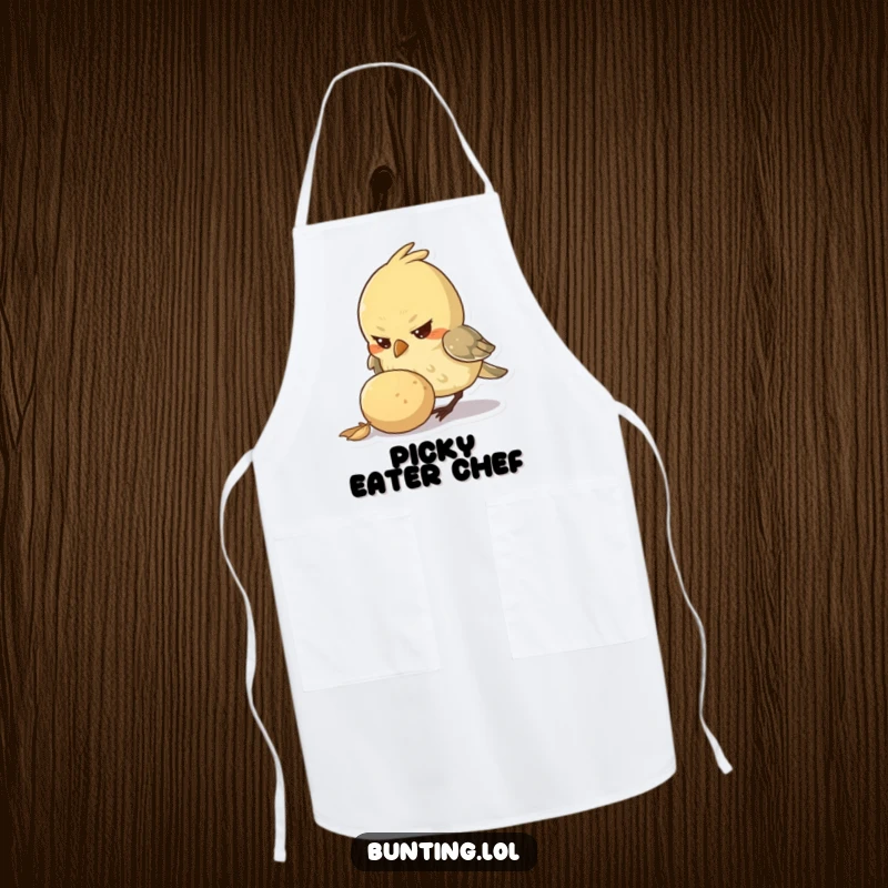 Funny Apron featuring a small bird character with a determined look, pecking at a large seed, ideal for cooking with focus and humor.