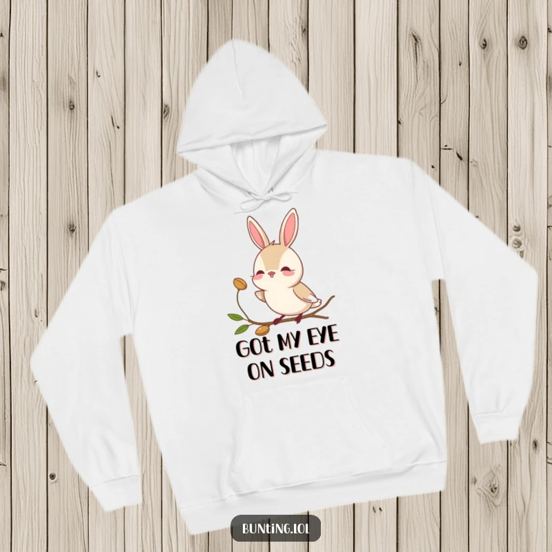 Funny bunting bird hoodie with a character tilting its head to observe a seed, embodying gentle curiosity.