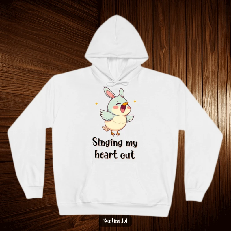 Funny bunting hoodie depicting a cute bird character cheerfully singing with its beak open, radiating warmth and musical bliss.