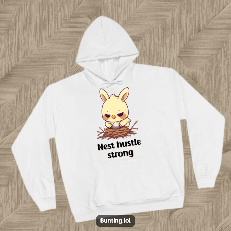 Funny bunting hoodie showing a determined bird diligently constructing a tiny nest, perfect for cozy, focused individuals.