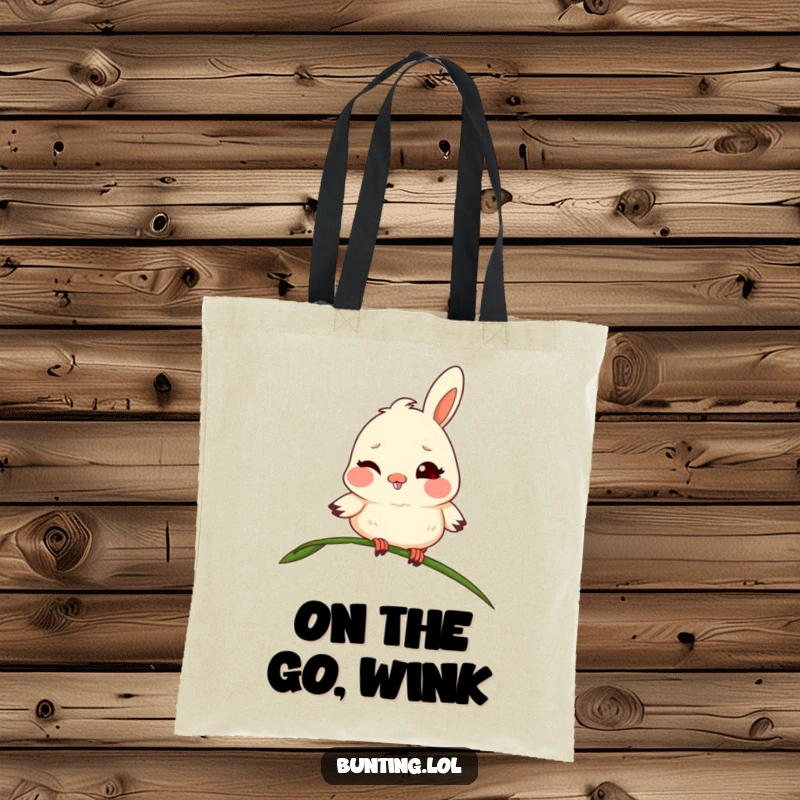 Funny bunting tote bag with a mischievous bird winking adorably from a blade of grass, a stylish and humorous accessory.